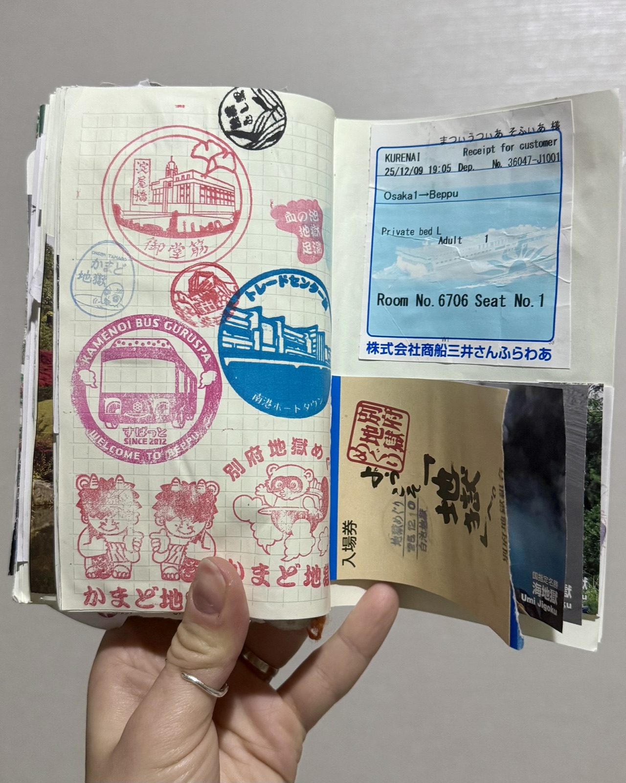 A travel journal page covered in stamps from a trip through Japan