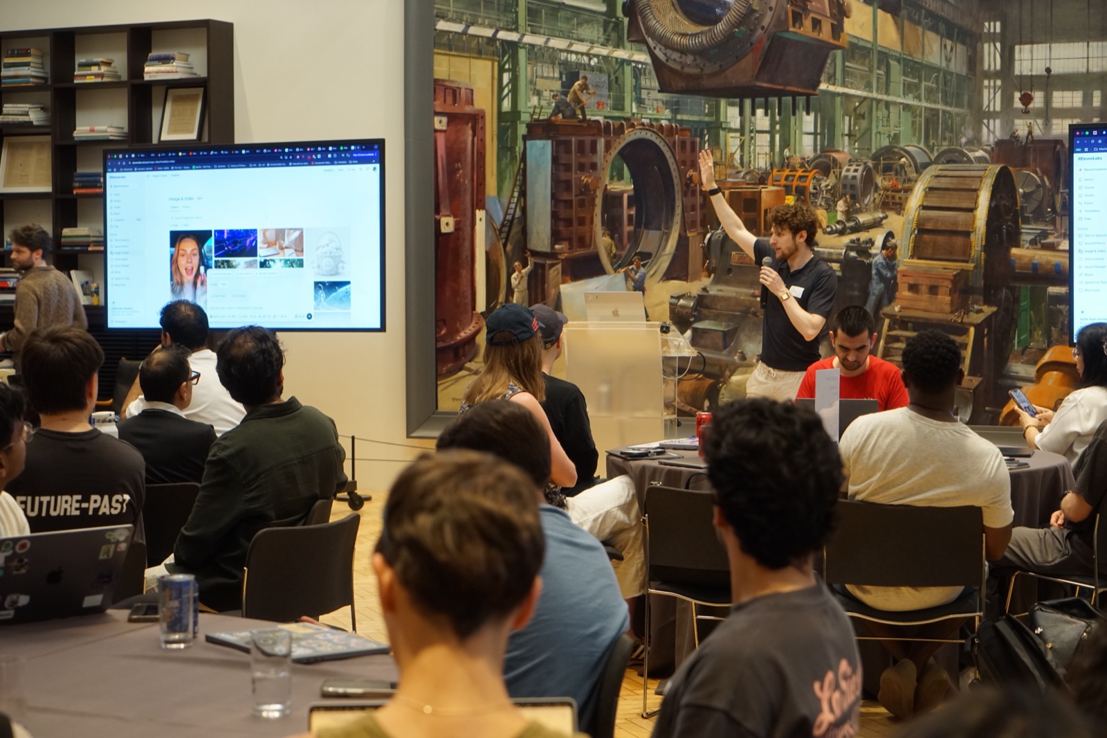 A speaker presenting to the group at a Vibe Coding Collective workshop