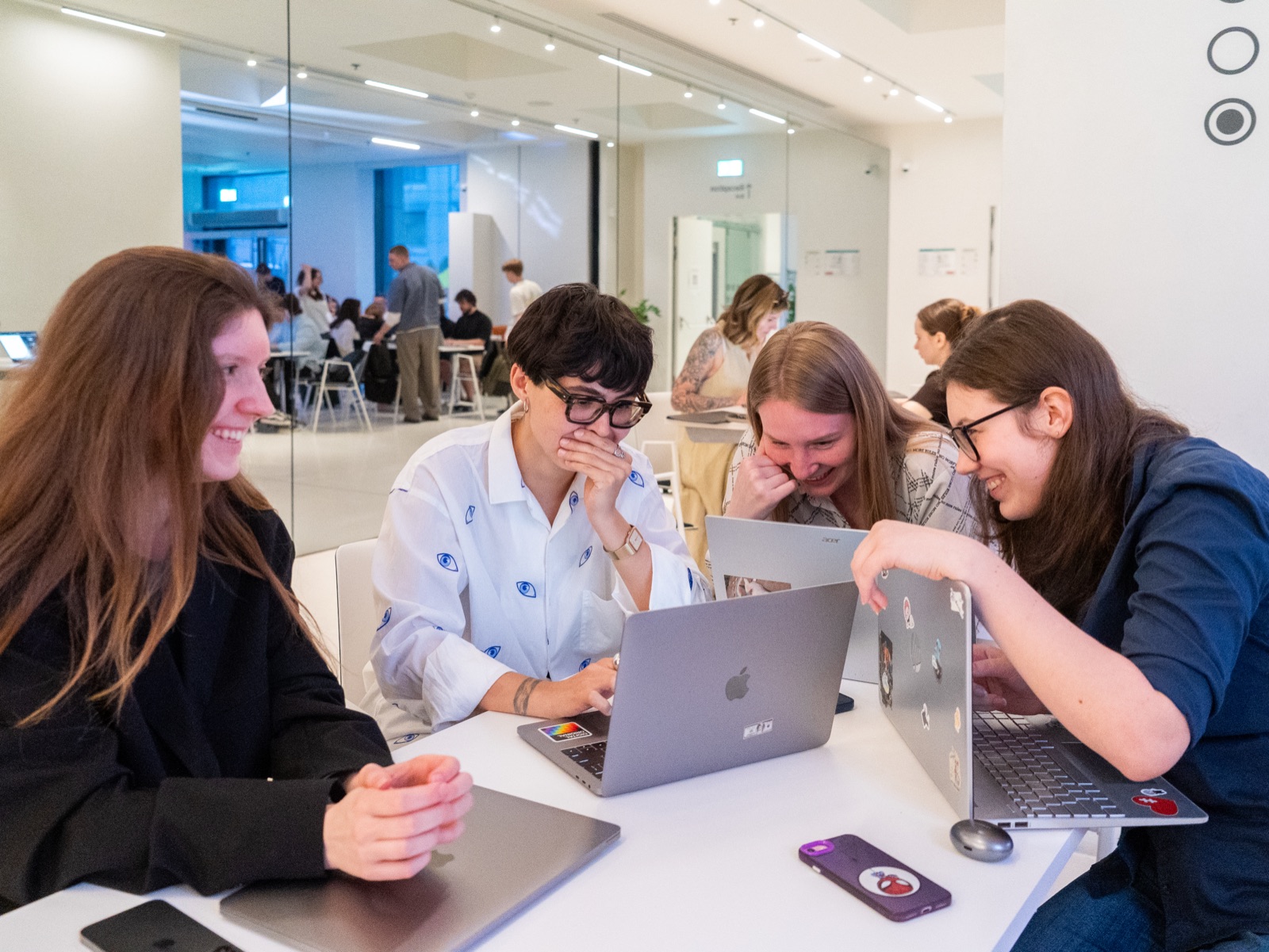 Vibe Coding Collective members laughing together while coding